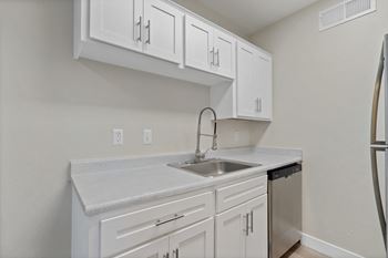 Kitchen with white cabinets and a sink and refrigerator at Elevation Apartments, Tucson